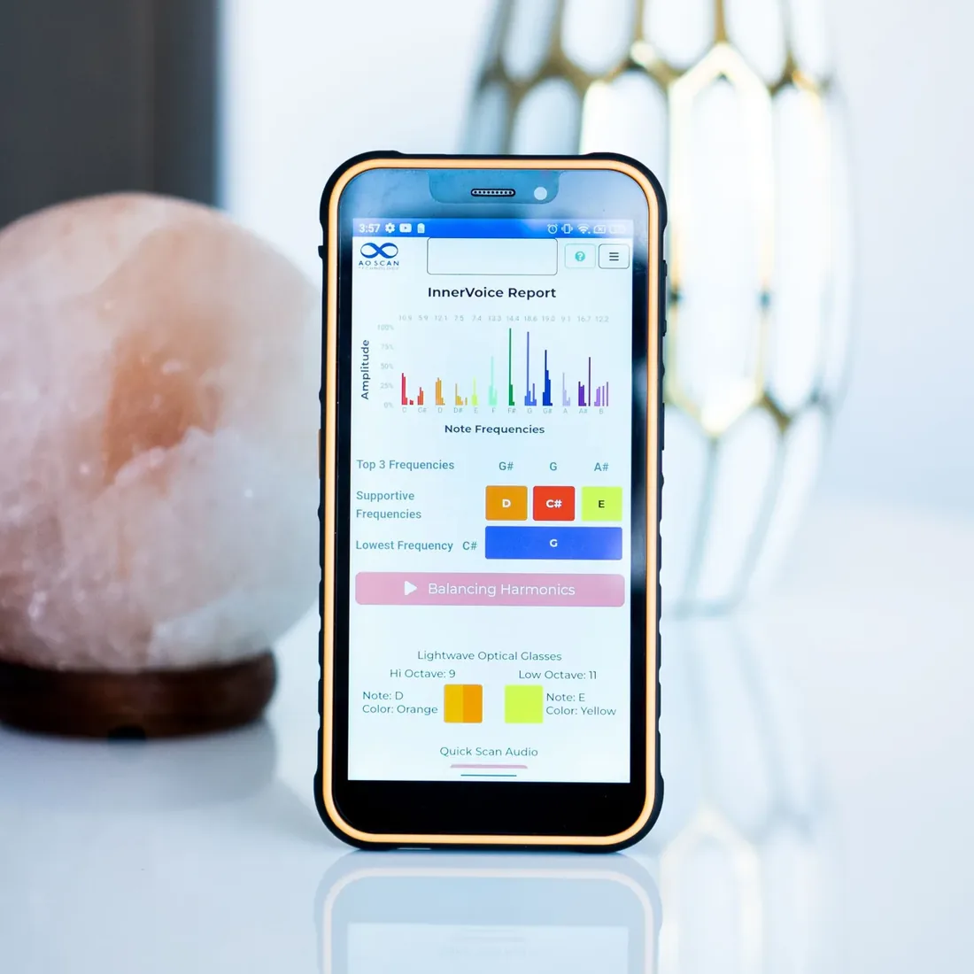 The Inner Voice frequency report on a phone beside a Himalayan salt lamp